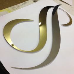 polished gold stainless steel office logo